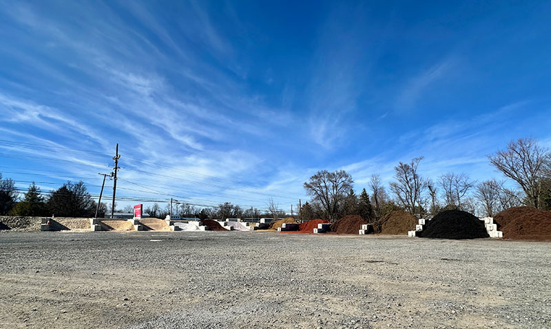 Landscape material supply yard bins with mulch, rock and stone products